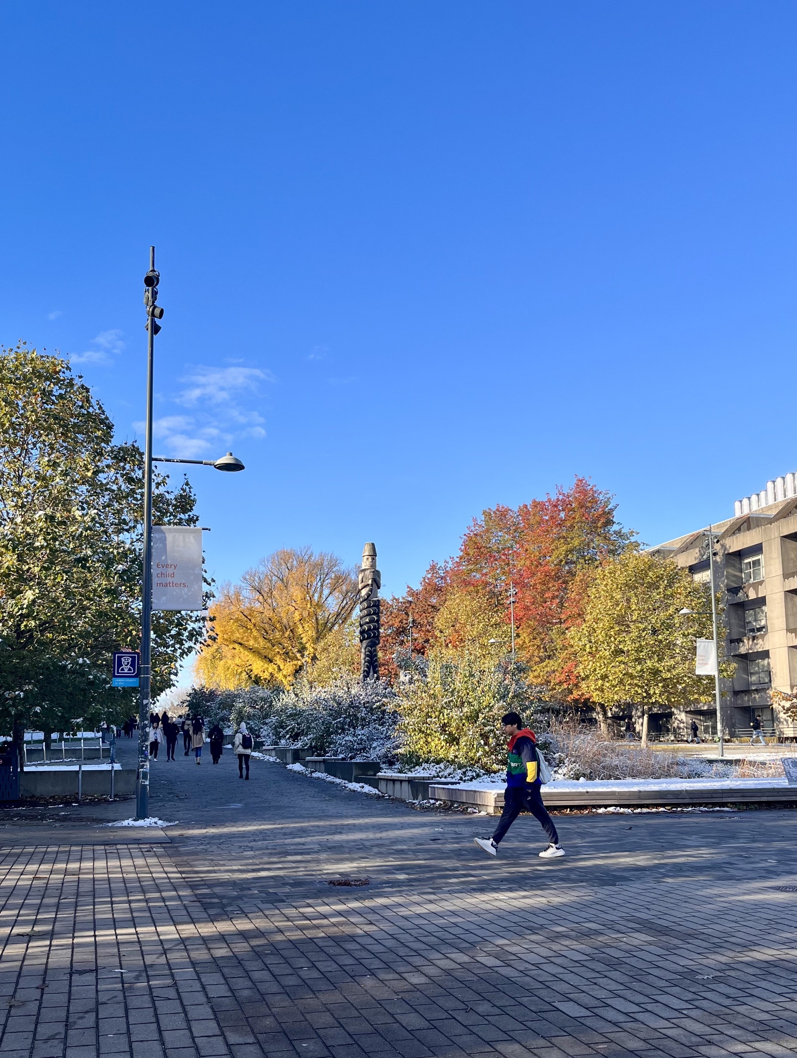 Students stroll through the plaza outside the bookstore on the way to class.