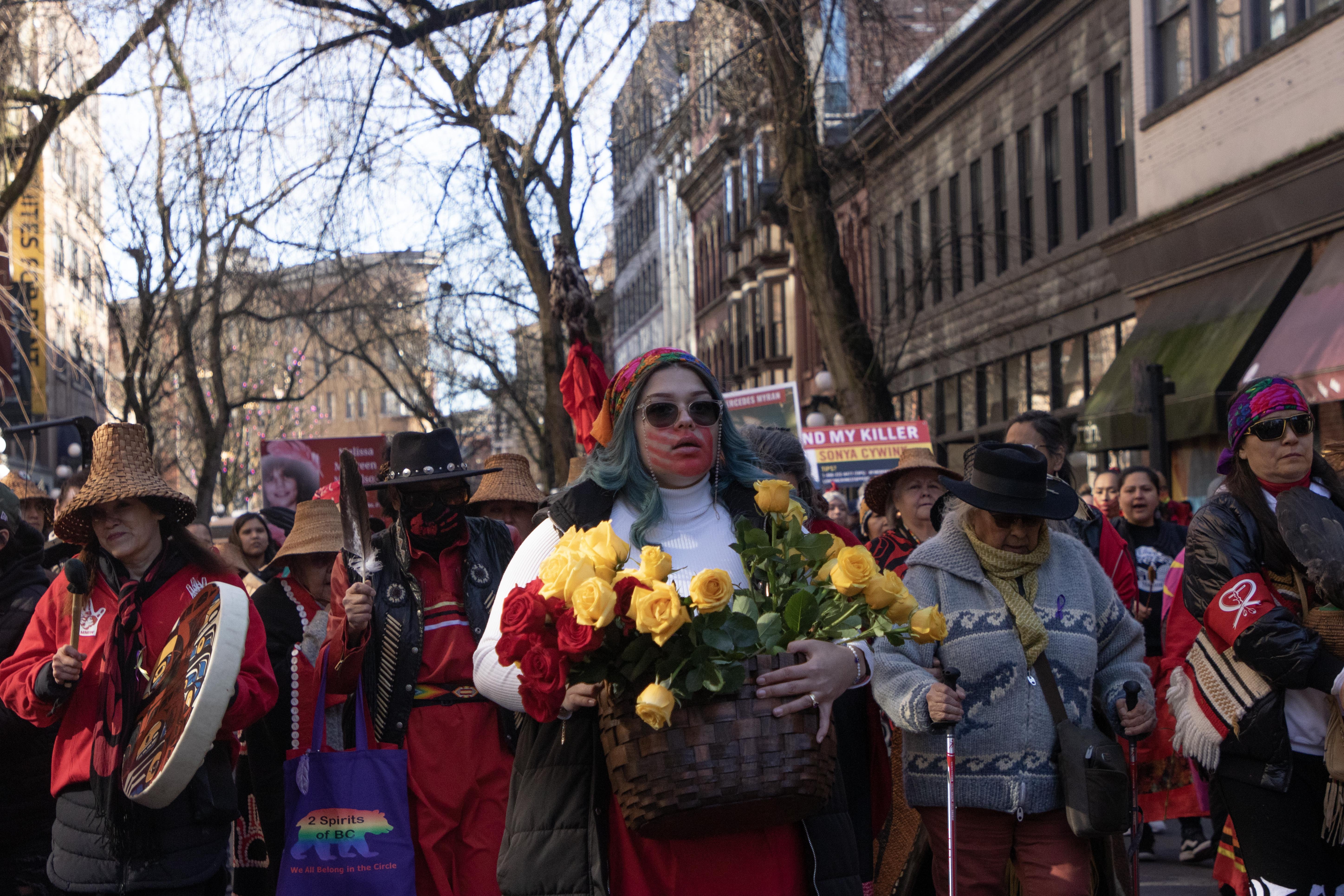 The march began at Main and Hastings and proceeded through Gastown, with participants singing healings songs, drumming and scattering flower petals.